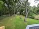 Large backyard featuring a lawn, mature trees and bordering a wooded area, offering privacy at 1298 Belmont Se Ave, Smyrna, GA 30080