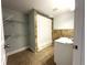 Bathroom with neutral tile, white shelving, and a shower/tub with a curtain at 1298 Belmont Se Ave, Smyrna, GA 30080