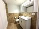 Full bathroom with tile surround, updated vanity, and toilet at 1298 Belmont Se Ave, Smyrna, GA 30080