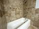 Close up of a tub with tile surround and a shower head at 1298 Belmont Se Ave, Smyrna, GA 30080