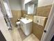 Bathroom featuring a shower, sink and mirror with decorative tile backsplash at 1298 Belmont Se Ave, Smyrna, GA 30080