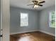Bedroom features wood floors, neutral paint, ceiling fan, and two windows at 1298 Belmont Se Ave, Smyrna, GA 30080