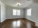 Bedroom features hardwood floors, neutral paint, and large windows at 1298 Belmont Se Ave, Smyrna, GA 30080