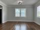 Dining room featuring hardwood floors, a modern light fixture, and bright windows at 1298 Belmont Se Ave, Smyrna, GA 30080