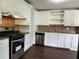 Kitchen featuring stainless steel appliances, white cabinets, and granite countertops at 1298 Belmont Se Ave, Smyrna, GA 30080