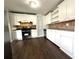 Modern kitchen featuring stainless steel appliances, white cabinetry, and laminate countertops and flooring at 1298 Belmont Se Ave, Smyrna, GA 30080