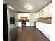 Modern kitchen featuring stainless steel appliances, white cabinetry, and laminate countertops and flooring at 1298 Belmont Se Ave, Smyrna, GA 30080