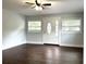 Living room features wood floors, neutral paint, windows, and a ceiling fan at 1298 Belmont Se Ave, Smyrna, GA 30080