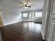 Bright living room features wood flooring, ceiling fan, and natural light from the windows at 1298 Belmont Se Ave, Smyrna, GA 30080