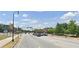 Well-maintained street with pedestrian walkways, street lights, and visible local businesses at 1298 Belmont Se Ave, Smyrna, GA 30080