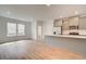 Open-concept kitchen with gray cabinets, stainless steel appliances, and hardwood floors at 3151 Washburn Sw St, Atlanta, GA 30354