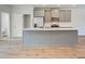 Modern kitchen with gray cabinets, stainless steel appliances, quartz countertops, and hardwood floors at 3151 Washburn Sw St, Atlanta, GA 30354