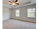 Spacious main bedroom featuring plush carpet, ceiling fan, and tray ceiling at 3151 Washburn Sw St, Atlanta, GA 30354