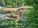 Aerial view of backyard with deck, patio, green lawn area and mature trees at 4696 Dunover Cir, Dunwoody, GA 30360