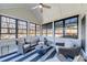 Cozy sunroom with multiple chairs, overhead fan, and many windows at 6055 Climbing Rose Way, Cumming, GA 30041