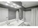 Bathroom featuring double sinks, white cabinets, large mirror, tub, and shower combo at 1307 Calderwood Se Ct, Smyrna, GA 30080