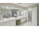 Bright bathroom featuring double sinks, a vanity, a walk-in shower, and marble floors at 1307 Calderwood Se Ct, Smyrna, GA 30080