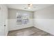 Bedroom with modern flooring, natural lighting, wainscoting, and neutral paint at 1307 Calderwood Se Ct, Smyrna, GA 30080