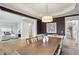 Spacious dining room featuring a large wooden table, stylish light fixture, and wainscotting at 1307 Calderwood Se Ct, Smyrna, GA 30080