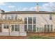 Back exterior view of home with windows, access to backyard, patio and wooden pergola at 1307 Calderwood Se Ct, Smyrna, GA 30080