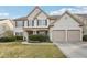 Charming two-story home featuring a manicured lawn and a two-car garage at 1307 Calderwood Se Ct, Smyrna, GA 30080