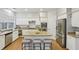 Well-lit kitchen featuring granite countertops, a center island, and stainless steel appliances at 1307 Calderwood Se Ct, Smyrna, GA 30080