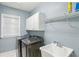 Well-lit laundry room featuring modern washer and dryer, sink, and ample cabinet storage at 1307 Calderwood Se Ct, Smyrna, GA 30080