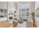 Bright and airy living room with a fireplace, built-in shelving, and large windows at 1307 Calderwood Se Ct, Smyrna, GA 30080