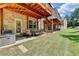Backyard with a patio, a table and chairs, and lush lawn, creating a great outdoor space at 2137 Post Grove Rd, Snellville, GA 30078