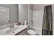 Clean bathroom features a shower-tub, toilet, modern sink, and vanity with generous space at 2137 Post Grove Rd, Snellville, GA 30078