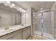 Elegant bathroom featuring double sinks, large mirror and walk-in shower at 2137 Post Grove Rd, Snellville, GA 30078