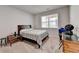 Cozy bedroom with neutral carpet, a window, and furniture, creating a comfortable and inviting space at 2137 Post Grove Rd, Snellville, GA 30078