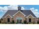 Exterior of the community clubhouse features a stone facade and manicured landscaping at 2137 Post Grove Rd, Snellville, GA 30078
