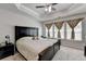 Main bedroom boasts a tray ceiling, ceiling fan, and a sunny window at 2137 Post Grove Rd, Snellville, GA 30078