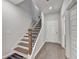 Modern stairway with hardwood steps and a black iron railing, leading to the upper level of the home at 2137 Post Grove Rd, Snellville, GA 30078