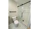 Updated bathroom showcasing a sliding glass door shower with white tile and black fixtures at 2745 Marco Nw Dr, Atlanta, GA 30318