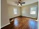 Inviting bedroom with hardwood flooring, a ceiling fan, and natural light streaming through two windows at 2745 Marco Nw Dr, Atlanta, GA 30318