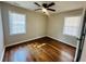 Bright bedroom with hardwood floors, a ceiling fan, and two windows illuminating the space at 2745 Marco Nw Dr, Atlanta, GA 30318