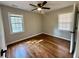 Charming bedroom with hardwood floors, a ceiling fan, and two bright windows at 2745 Marco Nw Dr, Atlanta, GA 30318