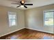 Comfortable bedroom with hardwood floors, ceiling fan, and two windows providing natural light at 2745 Marco Nw Dr, Atlanta, GA 30318