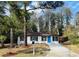 Charming single-story home featuring a blue front door, fresh landscaping, and a driveway at 2745 Marco Nw Dr, Atlanta, GA 30318
