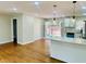 Open concept kitchen with granite countertop bar and view to wood deck through double doors at 2745 Marco Nw Dr, Atlanta, GA 30318