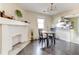 Cozy dining area with fireplace and open layout to a bright kitchen featuring stainless steel appliances at 1108 Sw Welch Sw St, Atlanta, GA 30310