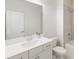 Clean bathroom features a sink with mirror, white cabinets, toilet, and a shower-tub combination at 1336 Rosen Rd, Brookhaven, GA 30319