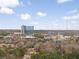 Scenic shot of a city's commercial district featuring modern buildings and lush green trees with a partly cloudy sky at 1336 Rosen Rd, Brookhaven, GA 30319
