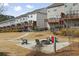 Landscaped common area with fire pit, Adirondack chairs, and open space for community enjoyment at 1336 Rosen Rd, Brookhaven, GA 30319