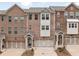 Charming brick townhome with well-maintained landscaping, front entryway, and two car garage at 1336 Rosen Rd, Brookhaven, GA 30319