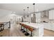 Modern kitchen with stainless steel appliances, quartz countertops, large island with bar seating, and hardwood floors at 1336 Rosen Rd, Brookhaven, GA 30319
