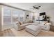 Bright living room with a large sectional sofa, decorative rug, and abundant natural light from the large windows at 1336 Rosen Rd, Brookhaven, GA 30319