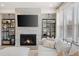 Relaxing living room with a fireplace, custom shelving, and a comfortable sectional sofa with plenty of natural light at 1336 Rosen Rd, Brookhaven, GA 30319